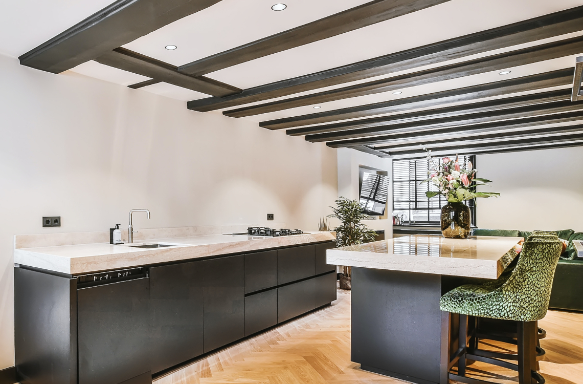 open plan spacious kitchen with ceiling-beams